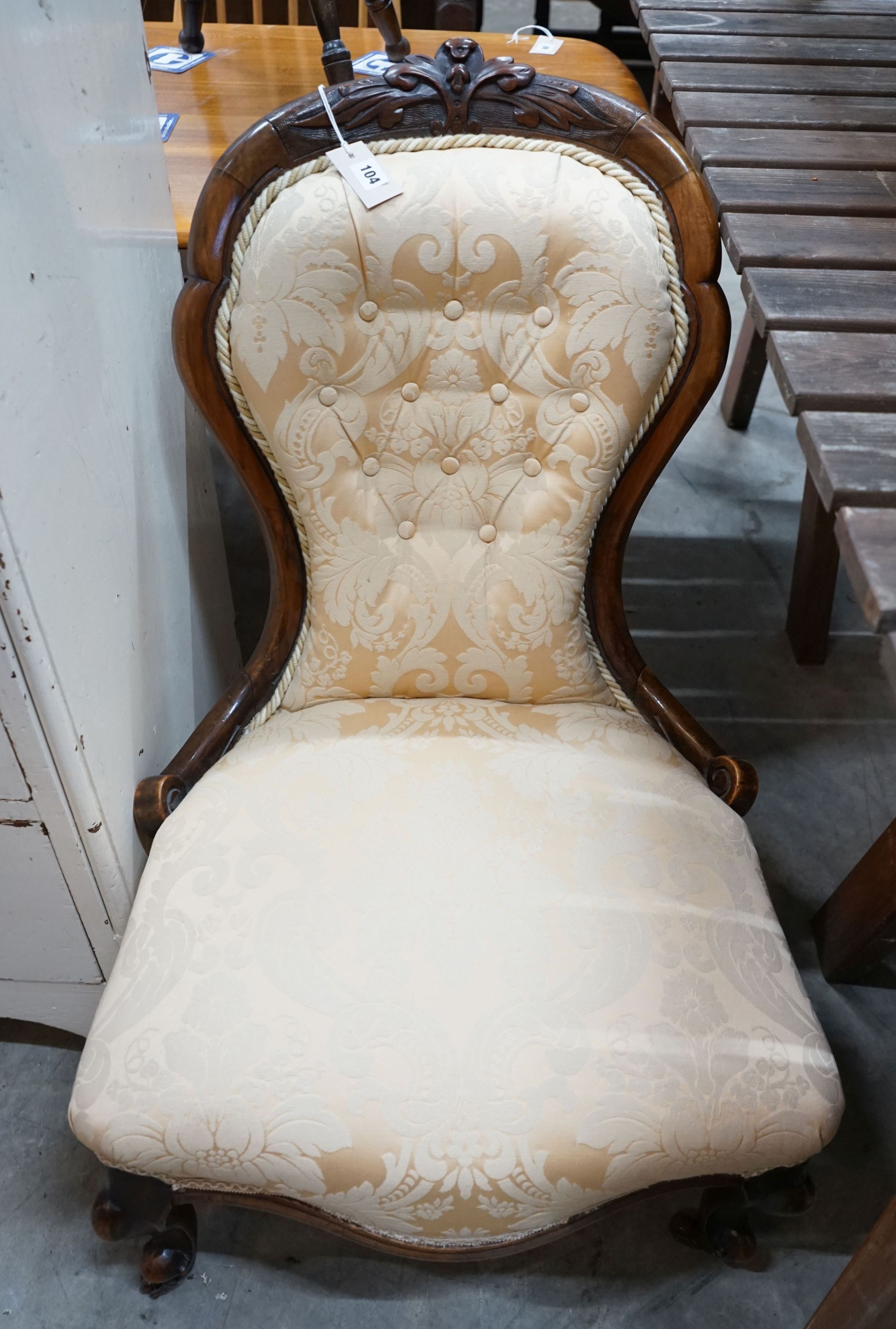 A Victorian walnut upholstered spoon back nursing chair